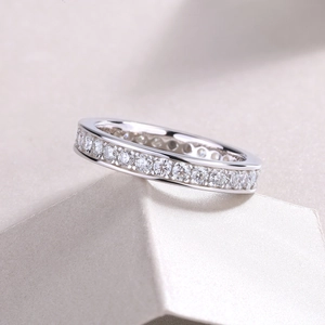 Macro view of S925 sterling silver eternity band featuring round-cut moissanite stones