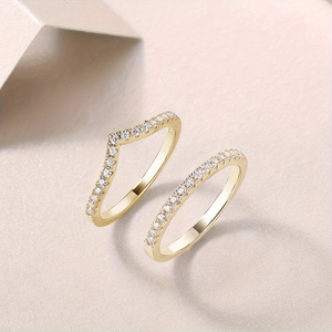 Detailed close-up of S925 sterling silver gold rings with V-shape and curved diamond band