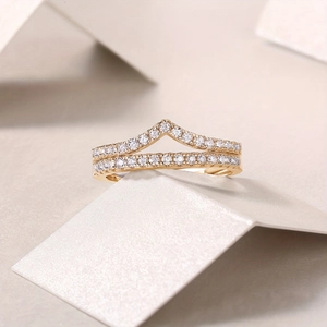 Macro view of stacked 18K gold plated S925 silver rings with pavé moissanite stones