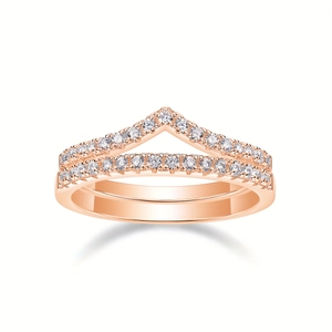 Close-up of stacked V-shaped and straight moissanite pavé rings in rose gold finish