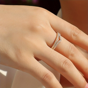 Close-up of a double-layered V-shaped 18K gold plated silver ring with moissanite