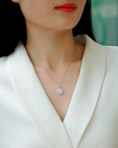 Close-up of S925 sterling silver halo moissanite pendant necklace on model neck