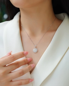 Close-up of S925 sterling silver halo necklace with round brilliant moissanite pendant