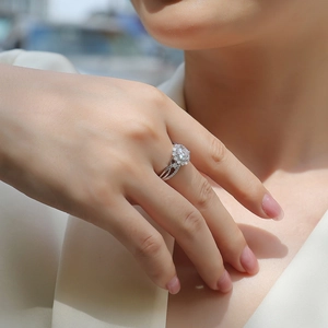 Detail of S925 sterling silver moissanite engagement ring with twisted band and flower setting