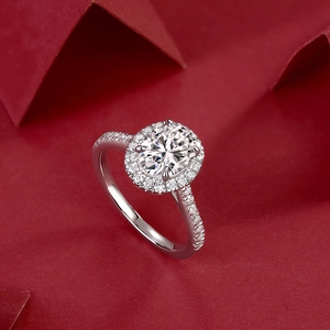 Elegant S925 sterling silver oval moissanite ring with halo setting on red background