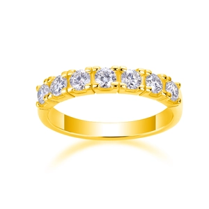 Macro shot of seven claw-set round moissanite stones on a polished 18K gold plated silver band