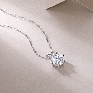 Detail of elegant 925 silver necklace featuring a six-prong set moissanite pendant on O-chain