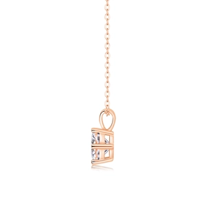 Detail view of rose gold four-prong necklace with a round-cut stone and delicate chain