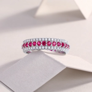 Macro shot of S925 sterling silver eternity ring with red gems and white micro-pavé diamonds