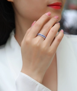 Close-up of S925 silver ring featuring blue sapphire and double row of white diamonds