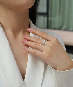 Close-up of S925 sterling silver ring with shimmering pave-set cubic zirconia on finger