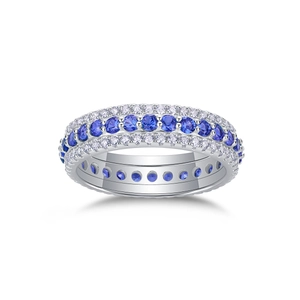 Macro shot of silver ring with triple row pave setting blue sapphires and white crystals