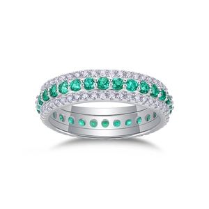 Detail of S925 sterling silver ring with three rows of emerald green and clear stones