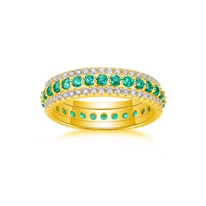 Detailed macro of gold ring with three rows of emerald and diamond style pavé stones