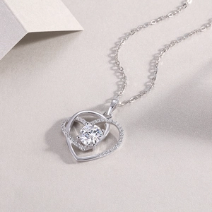 Macro shot of interlocking double heart pendant with round diamond in S925 sterling silver