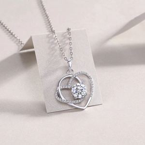 Detail of S925 silver double heart pendant with 1 carat lab diamond and cross chain