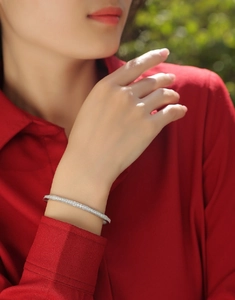 Elegant S925 sterling silver moissanite bracelet shown on wrist with a red shirt