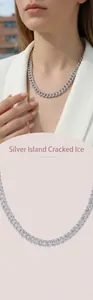 Close-up of a silver Cuban link necklace with sparkling stones on a female model