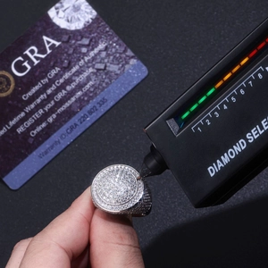 Macro shot of a moissanite tester pen checking a S925 sterling silver full eternity ring