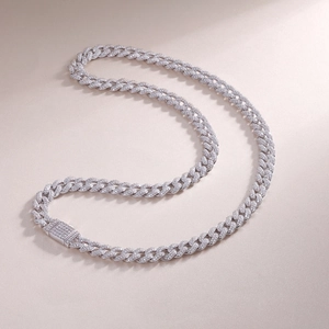 Detail view of silver Cuban link necklace with shimmering Moissanite pavé on luxury background