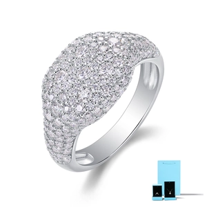 Macro view of pavé set round moissanite on a polished 925 sterling silver ring band