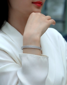 Detail of luxury S925 sterling silver bangle with moissanite pavé on a model's wrist