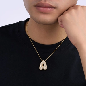 Close-up of a gold S925 silver necklace featuring a sparkling letter A pendant with zircons