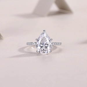 Vue détaillée d'une bague avec moissanite taille poire et anneau serti de diamants