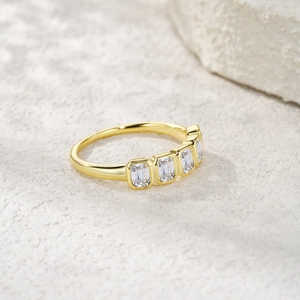 Vista dettagliata di un anello in argento S925 dorato con cinque moissaniti taglio smeraldo