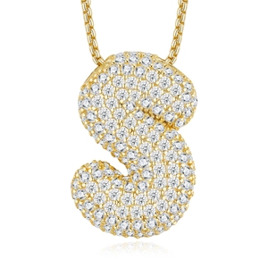 Macro shot of gold S-shaped pendant necklace with sparkling white moissanite pavé detail
