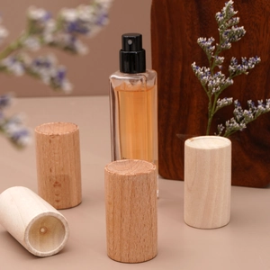 Macro detail of cylindrical wood essential oil diffusers showing natural texture and grain