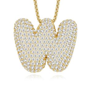 Close-up of a gold-plated letter W pendant with micro-pave moissanite stones