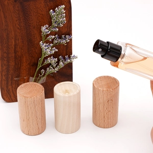 Natural wood cylindrical perfume bottle caps in various wood grains and light brown tones
