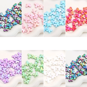 Detailed collection of colorful acrylic butterfly beads in various iridescent finishes for DIY