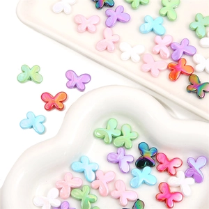 Macro view of colorful acrylic butterfly beads in macaron shades for DIY jewelry making