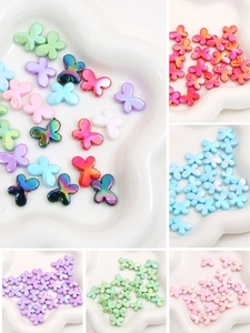 Macro shot of iridescent acrylic butterfly beads with colorful pearlescent finish for DIY crafts