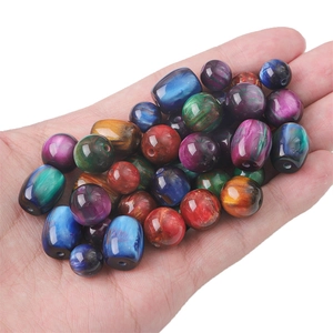 Assorted vintage resin starlight marble beads for DIY jewelry making held in palm