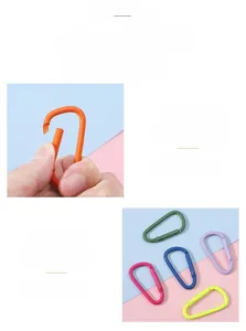 Detail of colorful D-ring carabiner keychains showing smooth paint finish and spring mechanism