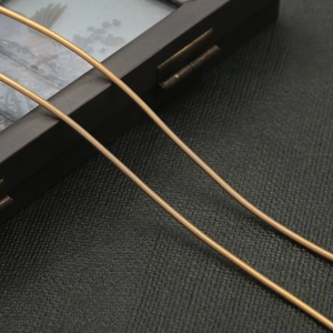Macro shot of matte bronze metal spring chain for DIY hair jewelry crafts