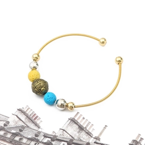 Ethnic style golden spring coil bracelet with colorful beads and vintage bronze charms