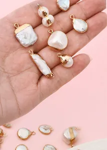 Macro view of irregular freshwater baroque pearl pendants with gold-plated edges for DIY jewelry