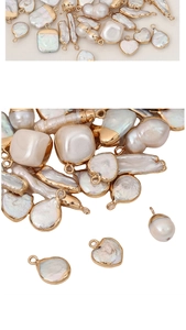 Macro detail of baroque freshwater pearls in various shapes with gold-plated metal edges