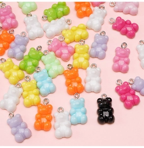 Macro shot of colorful resin gummy bear charms with metal rings for DIY jewelry