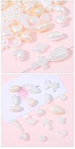 Macro shot of assorted cream white faux pearl beads in heart and floral shapes for DIY crafts