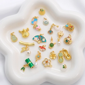 Macro detail of assorted Chinese style enamel fan and peanut charms for DIY jewelry making