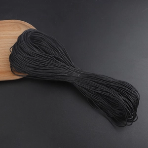 Detailed close-up of 1mm black waxed cotton cord roll for DIY handmade jewelry weaving