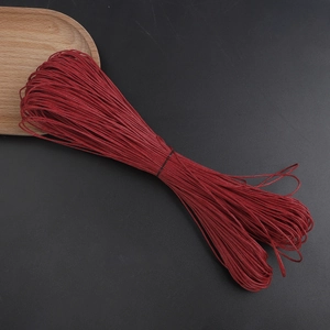 Detailed close-up of 1mm dark red waxed cotton cord for DIY jewelry making and weaving