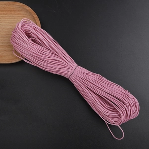 Macro detail of 1mm pink waxed cotton cord for DIY jewelry making and handmade crafts