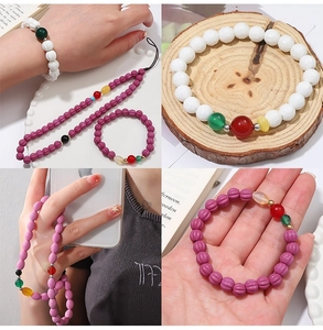 Detail of purple ceramic beads and handmade pumpkin-shaped faceted charms for DIY bracelets