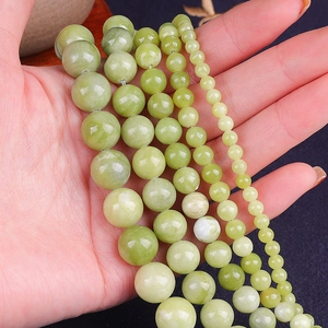 Macro detail of natural green jade beads in various sizes for DIY jewelry making